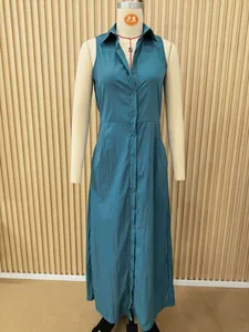 Full view of a teal sleeveless button-down shirt dress with lapel collar on a dress form