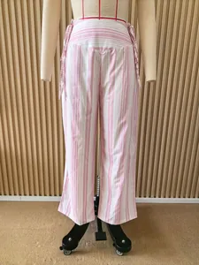Front view of pink and white striped low-waist wide-leg trousers with side tie detail.