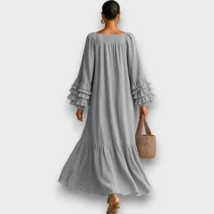 Back view detail of a loose grey maxi dress with layered ruffle sleeves and round neck.