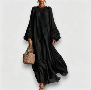 Elegant black maxi dress featuring pleated texture and multi-layered ruffle sleeves.