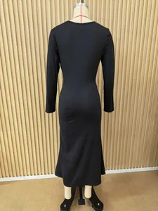 Full back view of a black long-sleeved slim-fit maxi dress displayed on a mannequin