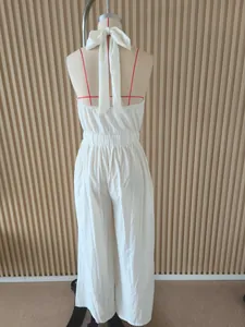 Back view detail of elegant white halter neck backless wide leg jumpsuit with bow tie