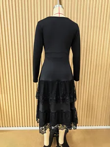 Back view detail of a French style black long-sleeved dress with tiered lace mesh