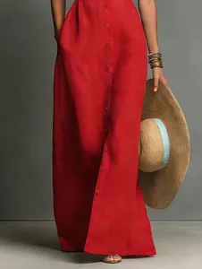 Detail of a red button-down sleeveless maxi dress with a textured linen-like fabric.