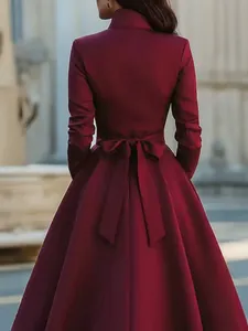 Elegant burgundy long-sleeve dress featuring a back tie bow and a classic A-line silhouette