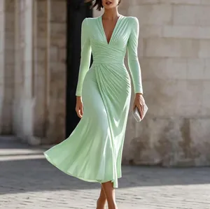 Elegant mint green V-neck long sleeve ruched midi dress worn by a model in a city setting.