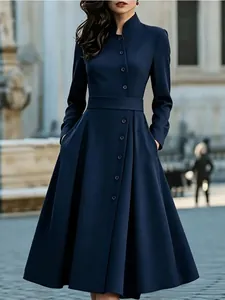 Elegant navy blue long sleeve button-down A-line midi dress with pockets and belt.