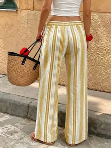 Back view of vibrant yellow and white striped wide-leg trousers with a drawstring waist