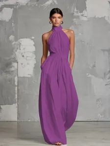 Detailed full view of an elegant purple halter neck wide-leg jumpsuit on a model