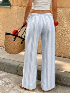 Back view of blue and white striped wide-leg trousers in a sunny leisure outdoor setting.