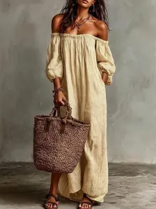 Detail view of an elegant off-the-shoulder striped maxi dress with bohemian puffed sleeves