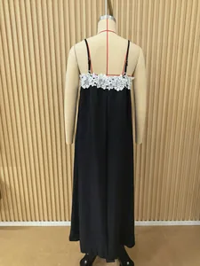 Back view of a black sleeveless maxi dress with white lace detail on a mannequin.