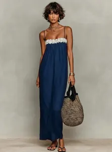 Close-up of navy blue summer holiday maxi dress featuring delicate white lace trim detail