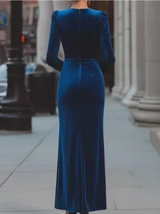 Elegant navy blue velvet long-sleeved evening gown showcasing sleek back view details
