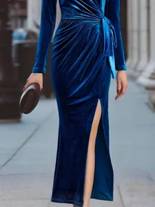 Detailed view of elegant deep blue velvet maxi dress with high slit and waist tie
