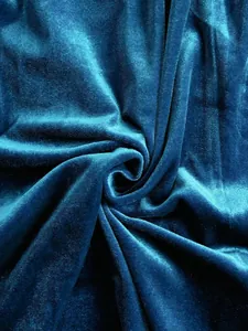 Macro view of high-quality teal velvet fabric showing soft texture and rich sheen.