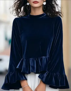 Detailed close-up of navy blue velvet top showing ruffle layers and bell sleeves
