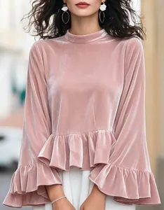 Detail view of pink velvet mock neck top with ruffle flare sleeves and peplum hem