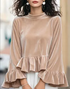 Close-up of elegant champagne velvet top with ruffled bell sleeves and round neck.