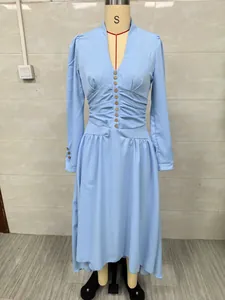 Elegant light blue long sleeve dress with V-neckline and decorative buttons displayed on mannequin