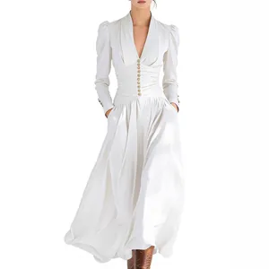 Detailed view of elegant white V-neck puff sleeve maxi dress with cinched button waist.