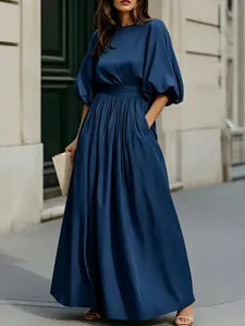 Elegante abito lungo blu navy stile francese con maniche a sbuffo e tasche pratiche