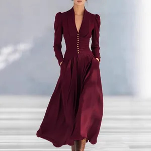 Elegant burgundy long dress featuring a V-neck, puff sleeves and gold buttons detail.