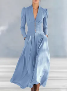Elegant light blue long-sleeve maxi dress with V-neck and cinched waist details