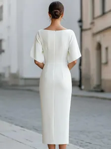 Elegant white midi dress back view featuring flared sleeves and a slim waistline detail