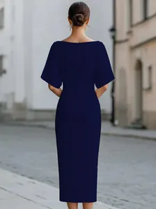 Elegant navy blue midi dress with short sleeves shown from behind in an urban street setting