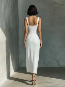Elegant white slim-fit sleeveless midi dress featuring a structured back and hidden zipper.