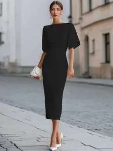 Elegant black midi dress with mid-length sleeves shown in an outdoor street setting