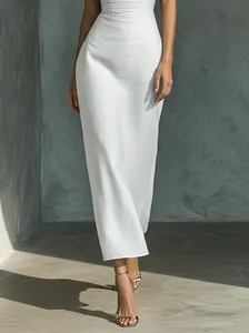 Detail of an elegant white slim-fit strapless dress with a textured fabric finish.