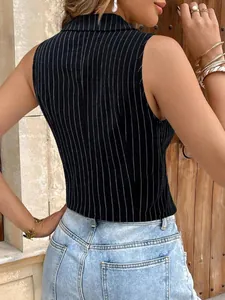 Rear view of a chic black and white striped sleeveless vest paired with denim jeans.