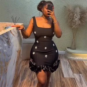 Sexy black bandage bodycon mini dress with crystal flower accents and ruffled hem.