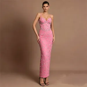 Full-body detail of elegant pink bandage dress with intricate rhinestone embellishments