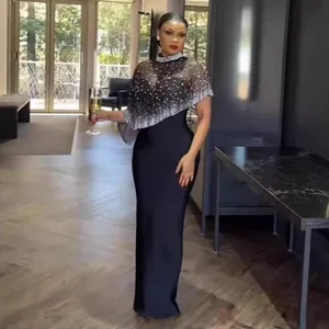 Elegant black evening gown featuring a shimmering rhinestone capelet detail