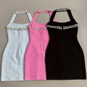 Detail view of three rhinestone halter bandage dresses in light blue, pink and black.