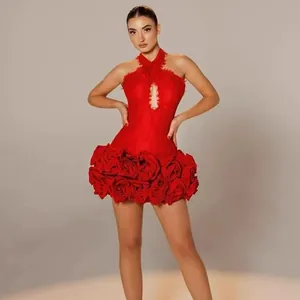 View of the intricate 3D rose appliqué details on the hem of this red sexy halter dress.