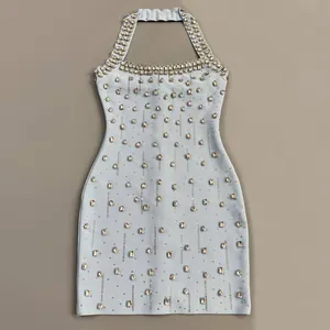 Detailed close-up view of light blue halter bandage mini dress with heavy crystal embellishments