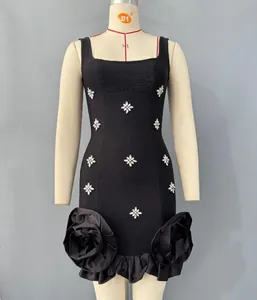 Black bandage mini dress with rhinestone star patterns and oversized floral ruffles