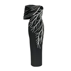 Detailed view of black bandage evening dress featuring coral-patterned rhinestone embellishments