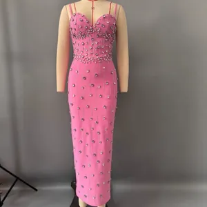Detail of pink bandage dress with shimmering rhinestone embellishments and slim fit