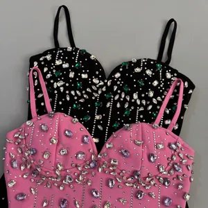 Detailed view of pink and black bandage dresses with sparkling rhinestones decoration