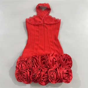 Close-up detail of a red halter bandage dress featuring elegant 3D fabric rose hemline