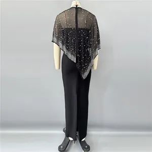 Detailed back view of an elegant black bandage evening dress with pearl and rhinestone shawl