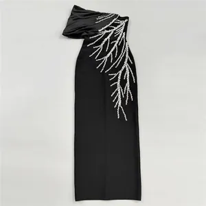 Detailed view of black bandage maxi dress featuring a sparkling crystal branch motif