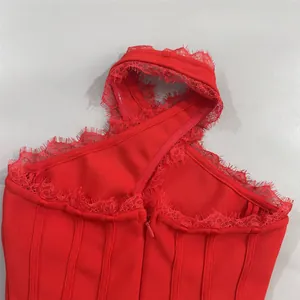 Close-up detail of sexy red bandage dress with elegant floral lace trim and cross halter neck