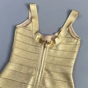 Close-up of a luxurious golden metallic bandage dress featuring a sleek back zipper detail