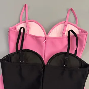 Detail showing adjustable straps and back zipper of pink and black bandage dresses.